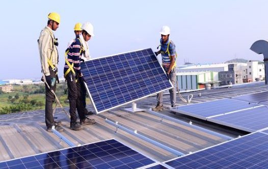 Netcco technicians installing a rooftop solar panel